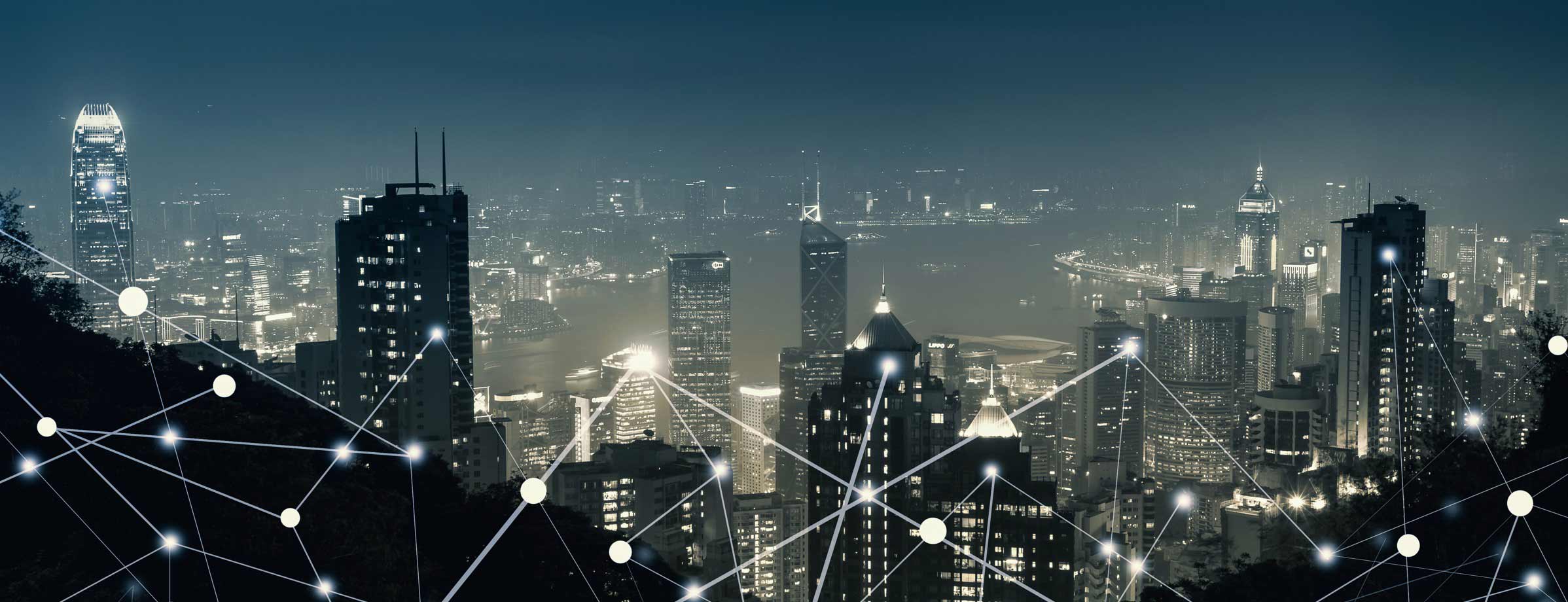 Cityscape at night with an overlay of lines representing network connectivity.